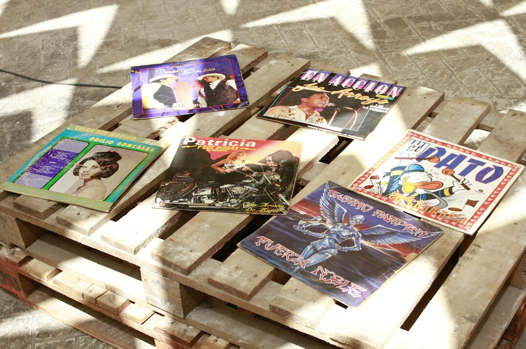Editora a rever fotografias antigas e revistas sobre uma mesa de madeira